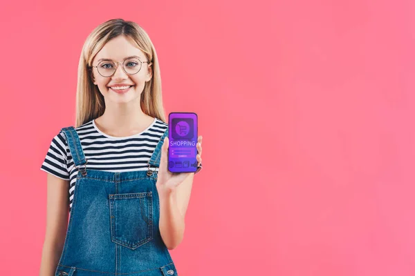 Portrait Smiling Woman Eyeglasses Showing Smartphone Shopping Sign Isolated Pink — Stock Photo, Image