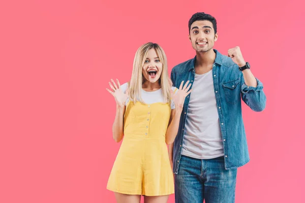 Excited Young Couple Gesturing Hands Looking Camera Isolated Pink — Stock Photo, Image