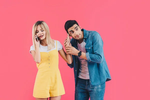 Irritated Young Woman Talking Smartphone Pushing Away Boyfriend Isolated Pink — Stock Photo, Image