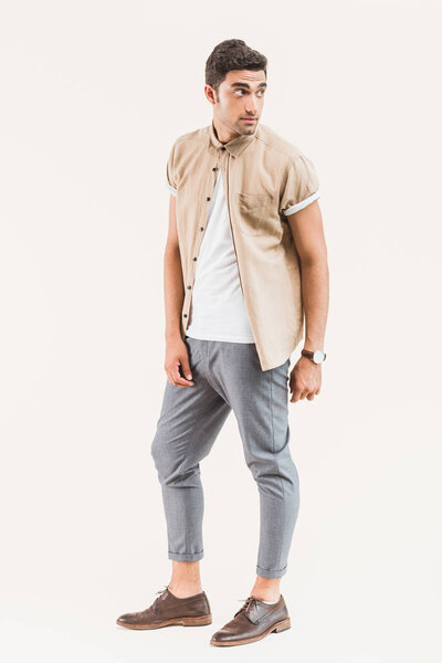 fashionable young man in shirt posing isolated on beige