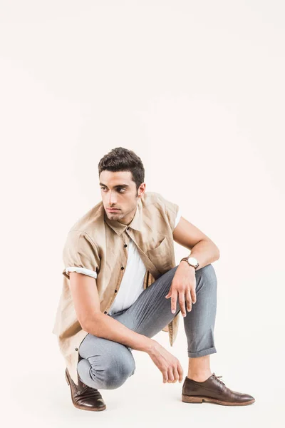 Serious Stylish Young Man Shirt Sitting Isolated Beige — Free Stock Photo