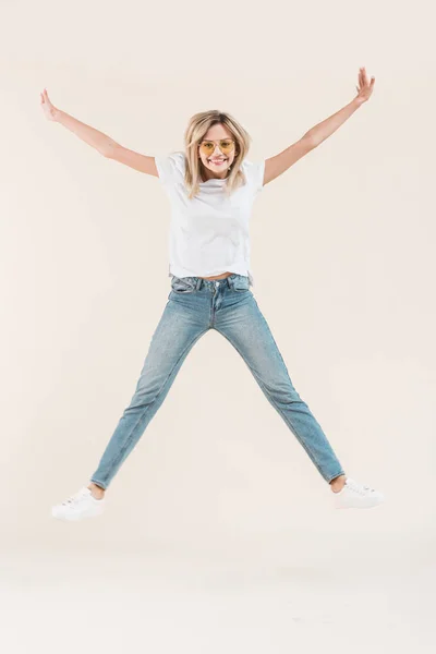 Happy Young Woman Eyeglasses Jumping Raised Arms Isolated Beige — Stock Photo, Image