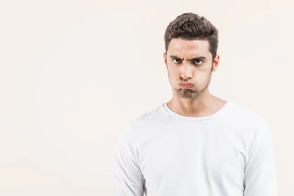 Angry Young Man Blowing Cheeks Looking Camera Isolated Beige — Stock Photo, Image