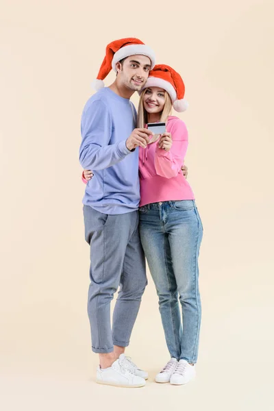 Feliz Jovem Casal Santa Chapéus Segurando Cartão Crédito Sorrindo Para — Fotografia de Stock