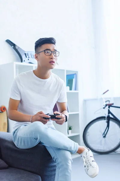 Upset Handsome Asian Man Playing Video Game Sofa Home — Free Stock Photo