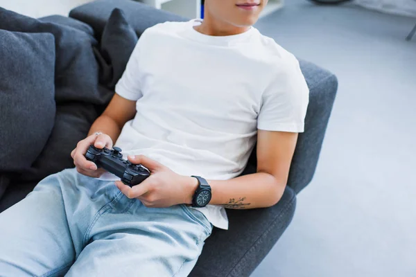 Cropped Image Asian Man Playing Video Game Lying Sofa Home — Free Stock Photo