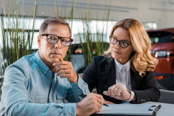 Adult Man Female Car Dealer Sitting Showroom Contract — Stock Photo, Image