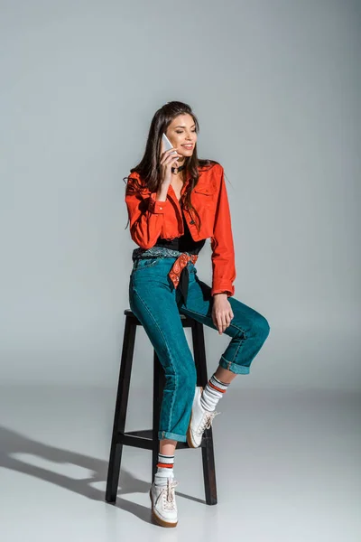 Smiling Girl Talking Smartphone While Sitting Stool Grey — Stock Photo, Image