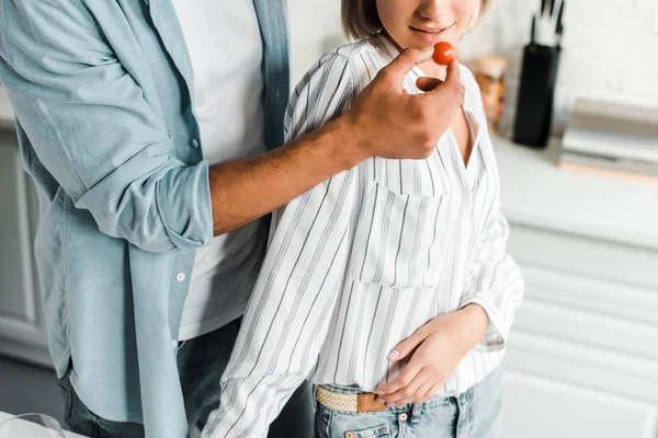 Imagen Recortada Novio Alimentación Novia Con Tomate Cereza Cocina — Foto de stock gratis