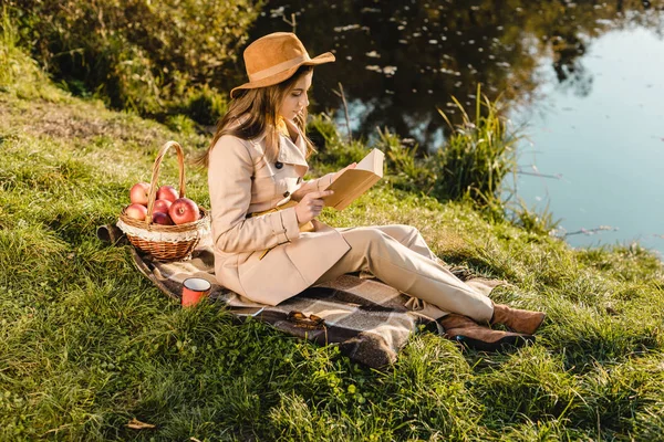 Side View Stylish Beautiful Woman Hat Reading Book Blanket Pond — Stockfoto