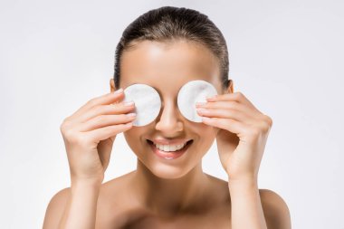 young smiling woman holding cotton pads on eyes  clipart