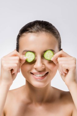 young smiling woman with cucumber slices on eyes clipart