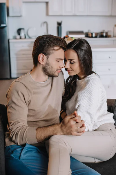 Beautiful Young Couple Cuddling Holding Hands Couch Home — Stock Photo, Image