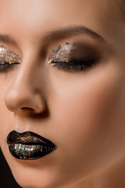 close up of young beautiful woman with glittery makeup and closed eyes