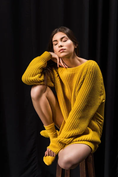 Woman Yellow Woolen Sweater Eyes Closed Sitting Bar Stool Black — Stock Photo, Image