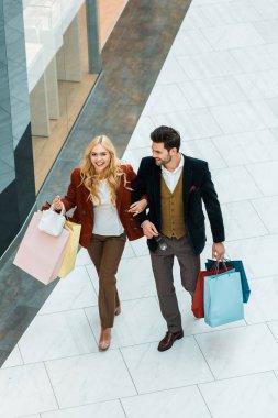 alışveriş alışveriş merkezinde yürüyen torbaları ile mutlu çiftin havai görünümü