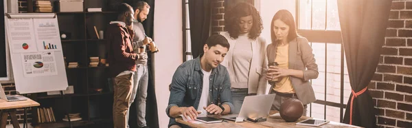 Casual Businesspeople Working Together Using Computer Loft Office Backlit Stock Photo