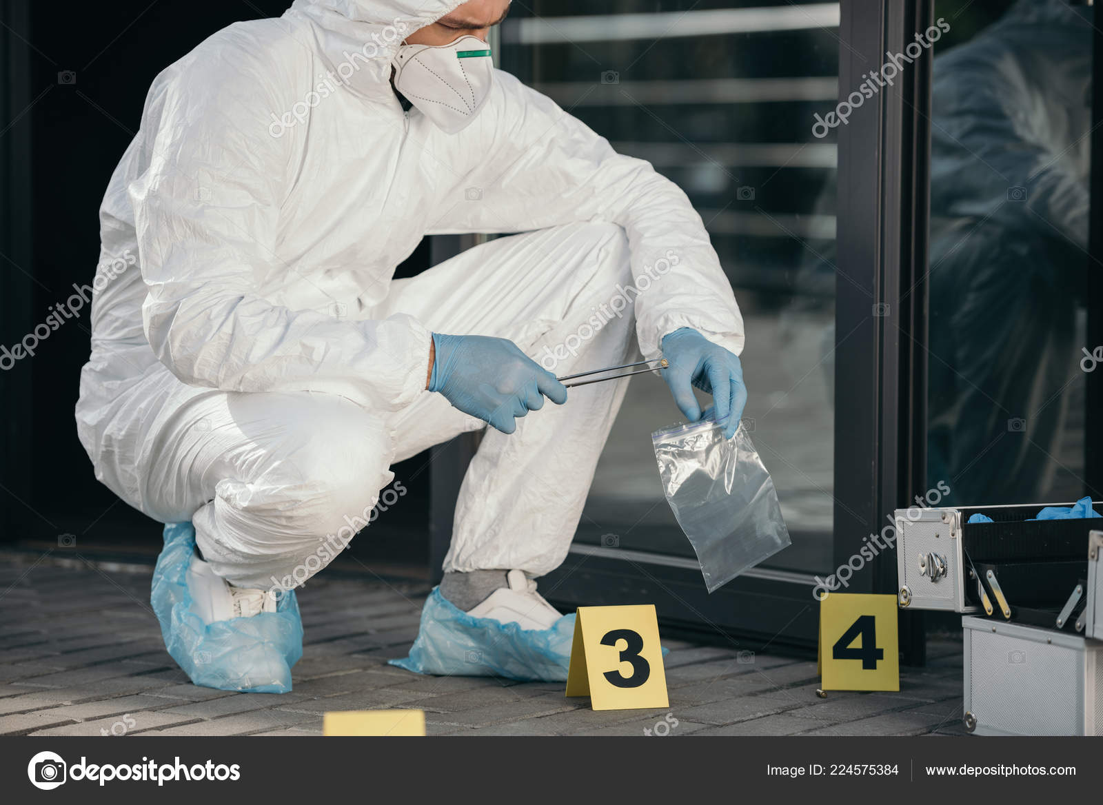 Male Criminologist Protective Suit Latex Gloves Packing Evidence Crime Scene Stock Photo by