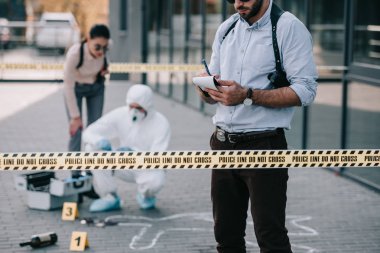 kadın ve erkek Dedektifler olay yerinde kriminoloji uzmanı ile
