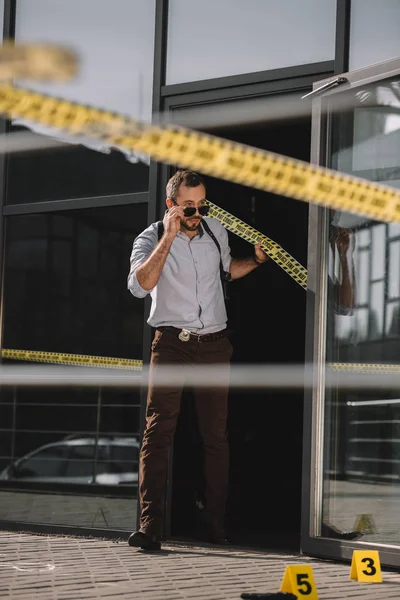 Male Detective Coming Out Building Straightening Sunglasses — Free Stock Photo