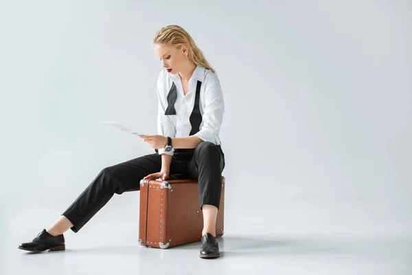 Attractive Blonde Girl Reading Newspaper While Sitting Retro Suitcase Grey — Stock Photo, Image