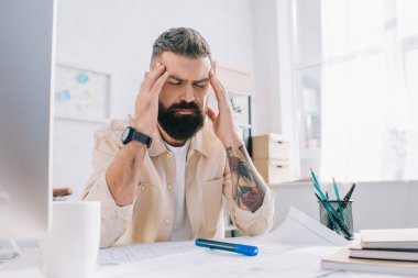 Modern ofis kapalı gözlerle masa başında oturan erkek mimar
