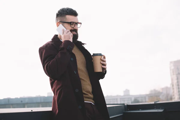 Stylish Adult Man Glasses Talking Smartphone Holding Coffee Rooftop — Free Stock Photo