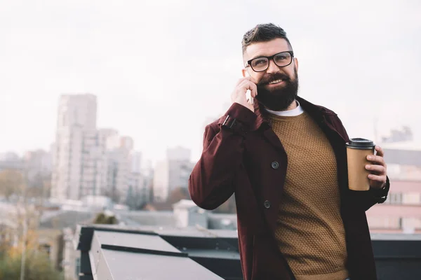 Stylish Adult Man Glasses Talking Smartphone Holding Coffee Rooftop — Free Stock Photo