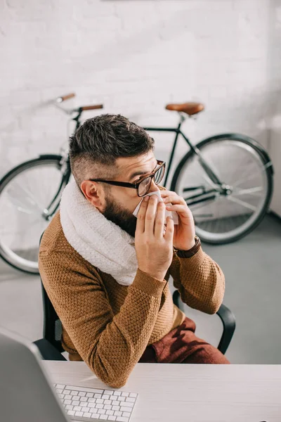 Sick Businessman Knitted Scarf Sitting Office Sneezing Covering Mouth Tissue — Stock Photo, Image