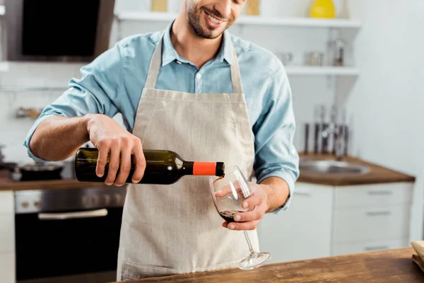 Cropped Shot Smiling Young Man Apron Pouring Wine Kitchen — Free Stock Photo