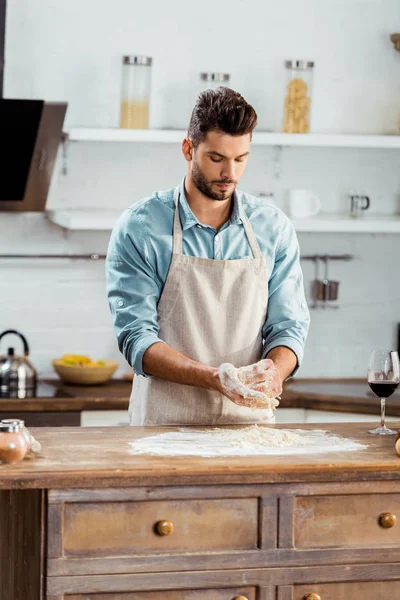 Focused Young Man Apron Preparing Dough Kitchen — Free Stock Photo
