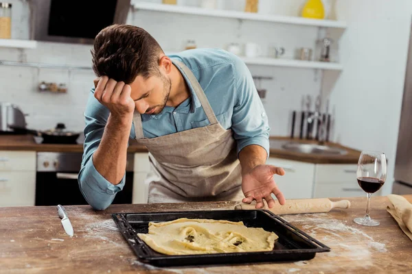 Upset Young Man Apron Leaning Table Spoiled Dough Baking Tray — Stock Photo, Image