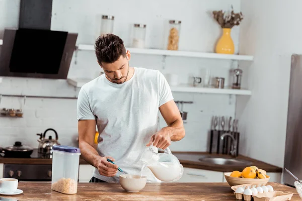 Young Man Pouring Milk Bowl Corn Flakes Morning — Stock Photo, Image