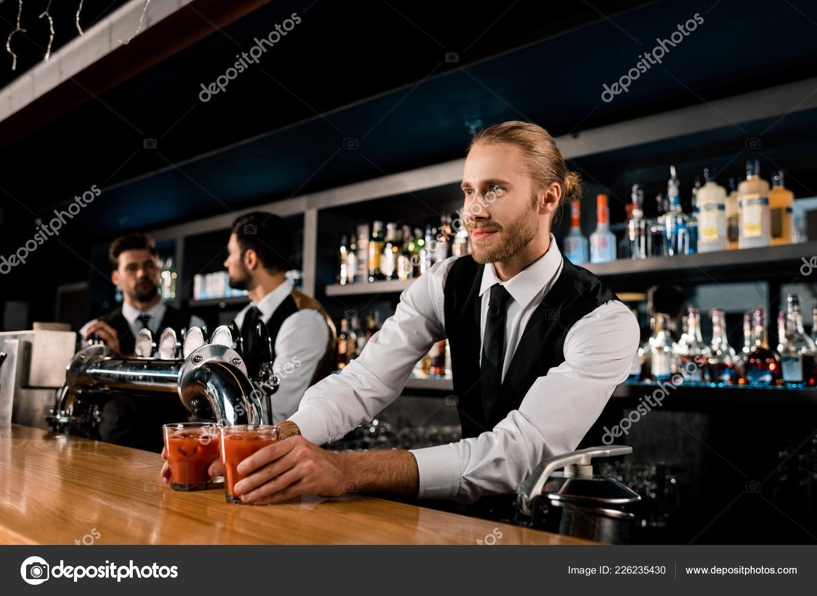 Handsome Bartender Serving Drinks Glasses — Stock Photo © VitalikRadko 226235430