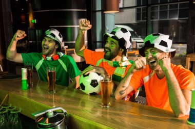 Football fans cheering and screaming in bar clipart