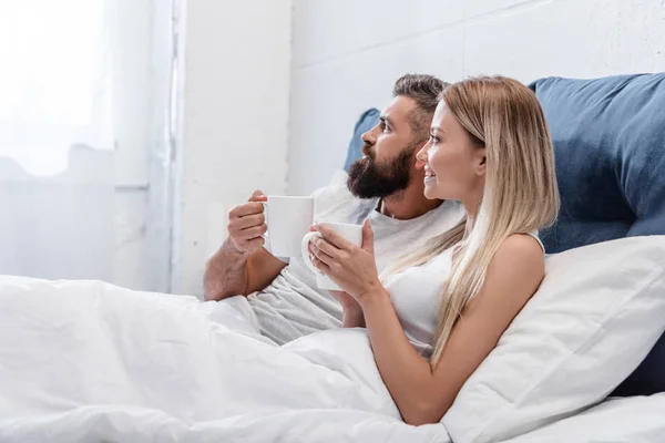 Pretty Couple Lying Bed Drinking Coffee Bright Bedroom Morning — Stock Photo, Image