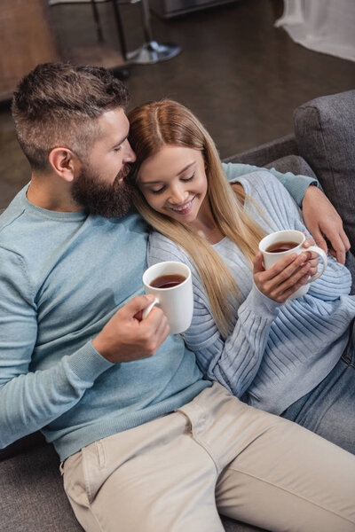 Happy couple sitting and smiling with drinks 