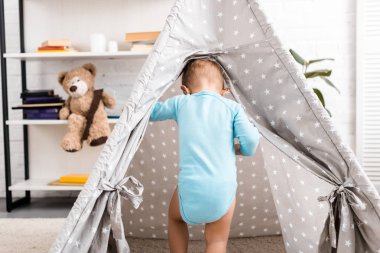 yürümeye başlayan çocuk gri bebek KızıIderili mavi gömlek ayakta