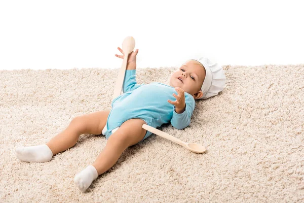 Toddler Boy Chefs Hat Two Big Wooden Spoons Lying Carpet — Free Stock Photo