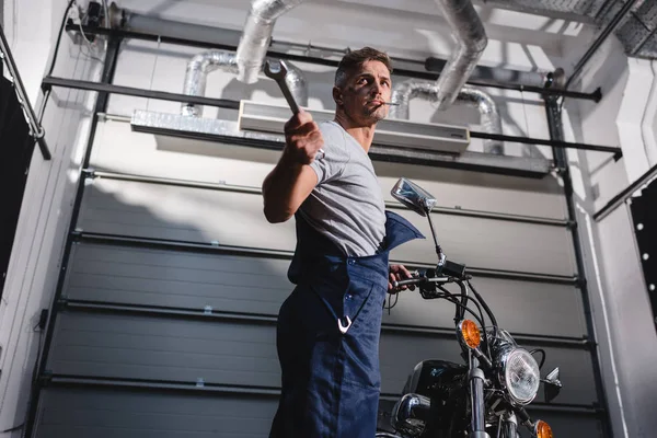 Mechanic Holding Wrench Fixing Motorbike Garage — Stock Photo, Image