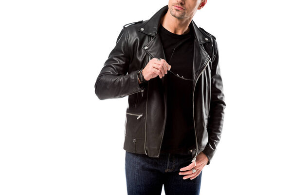 partial view of man in leather jacket holding sunglasses isolated on white