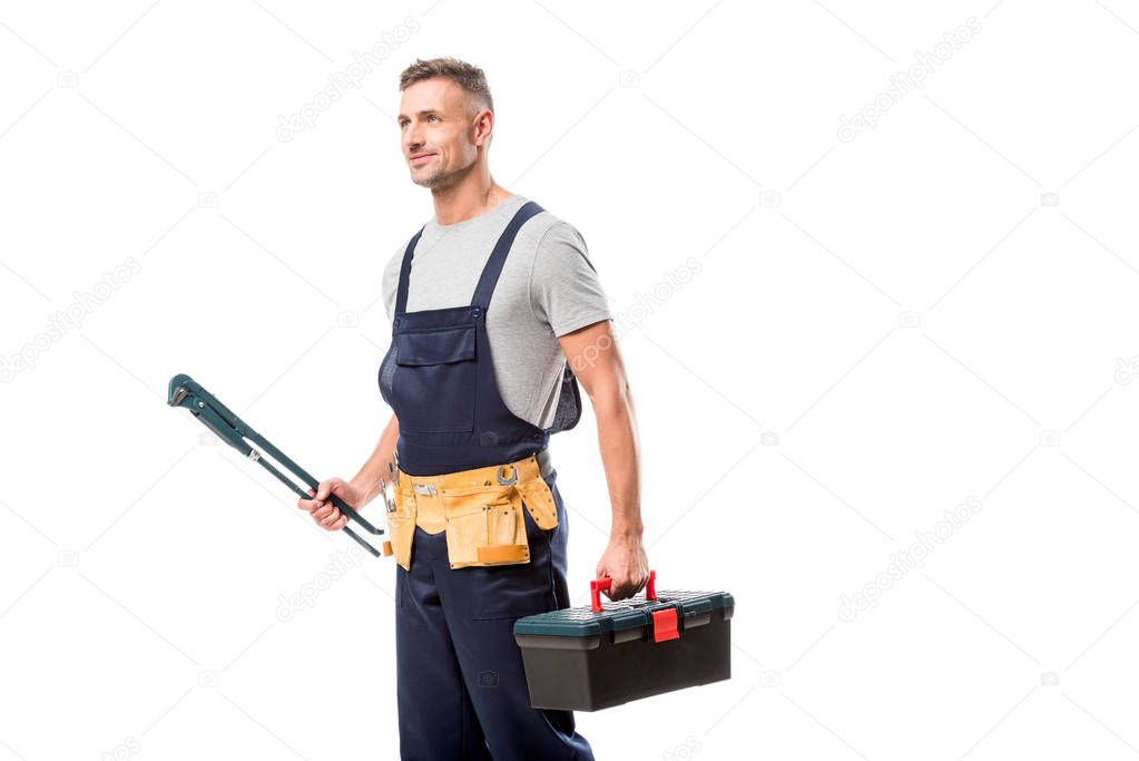 handsome worker holding pipe wrench and tool box isolated on white