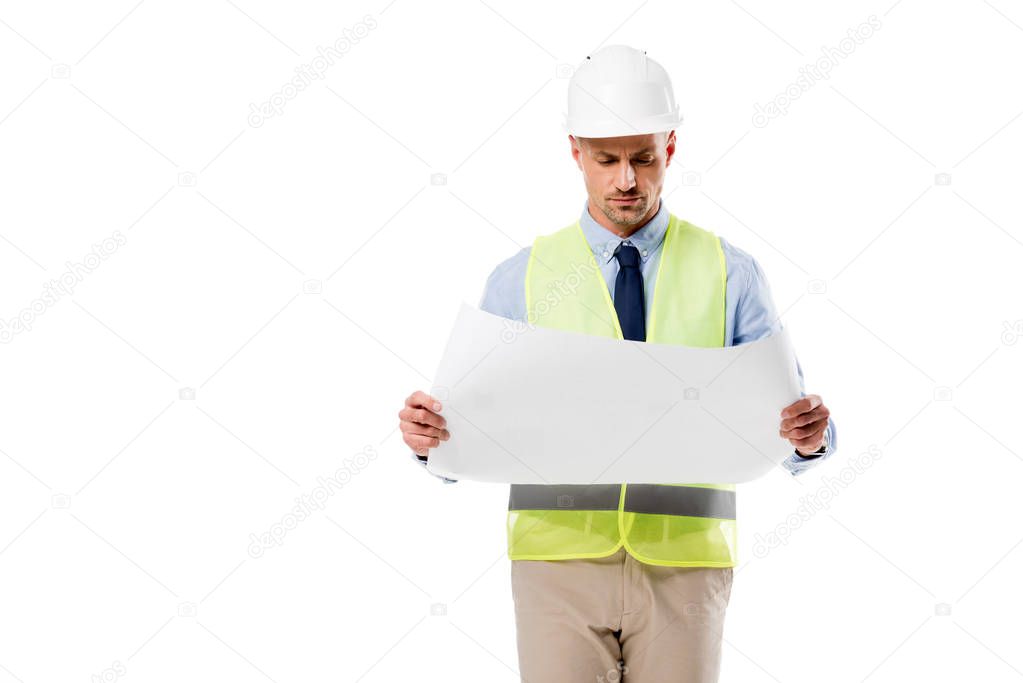 focused engineer in helmet holding blueprint isolated on white