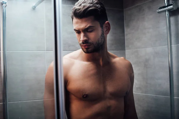 Selective Focus Serious Handsome Man Standing Glass Shower Doors Bathroom — Stock Photo, Image