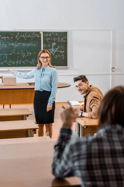 Selective Focus Smiling Female Teacher Pointing Chalkboard Hand While Male — Free Stock Photo