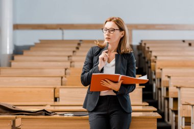 günlük tutan ve uzak sınıfta seyir dalgın kadın üniversite profesörü
