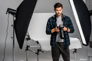 yakışıklı profesyonel genç fotoğrafçı fotoğraf makinesi fotoğraf Studio'yu kullanarak 
