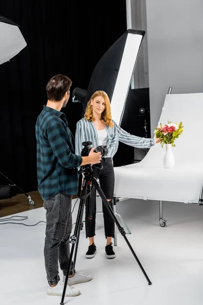 Young Photographers Looking Each Other While Shooting Flowers Studio — Free Stock Photo