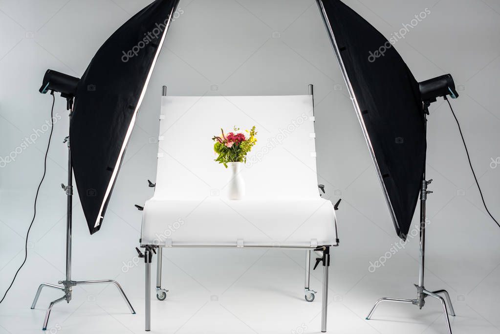 beautiful bouquet of flowers arranged in vase in professional photo studio  