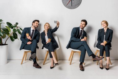 collage of smiling young business people with smartphone and paper cups waiting on chairs in line clipart